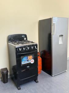 a stove next to a refrigerator in a room at Ducky 1 in San Miguel