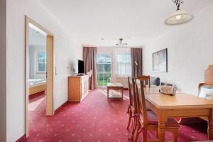 a living room with a dining room table and a bedroom at Superior Apt mit Seeblick K2 102 in Spalt