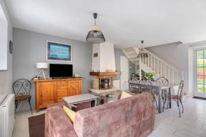 a living room with a couch and a table at Maison - Le Clos Des Pommiers in Pleudihen-sur-Rance
