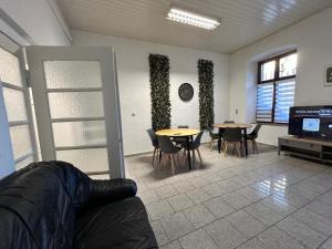 a living room with tables and chairs and a couch at Central Apartments Hof in Hof +42 photos