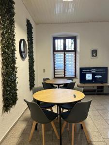 two tables and chairs in a room with a window at Central Apartments Hof in Hof