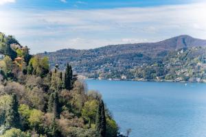 a view of a lake with trees and houses at LEtoile du Lac in Blevio