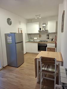 a kitchen with a refrigerator and a table in it at Casa Milele in Viareggio