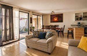 a living room with a couch and a dining room at Casa Maya in San Salvador