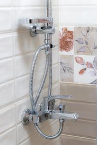 a shower head on a wall in a bathroom at Navial in Gabrovo +44 photos