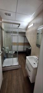 a bathroom with a glass shower and a sink at DM Hostel and Apartments in Skopje +46 photos