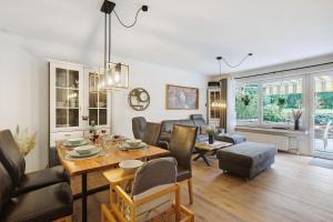 a dining room and living room with a table and chairs at Ferienwohnung Dornröschen in Olpe