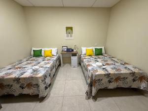 a room with two beds and a table in it at Ducky 1 in San Miguel
