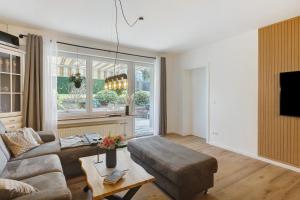 a living room with a couch and a table at Ferienwohnung Dornröschen in Olpe