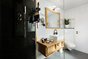 a bathroom with a sink and a mirror and a toilet at Ferienwohnung Dornröschen in Olpe +31 photos