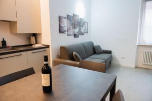a bottle of wine sitting on a table in a living room at Diamante Luxury Apartment in Torri del Benaco