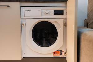 a washing machine in a cabinet in a room at Diamante Luxury Apartment in Torri del Benaco