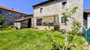 an old stone house with a yard in front of it at La forge in Saint-Julien-le-Petit +11 photos