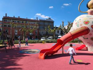 a playground with people playing on a slide at Hotel Vila Luena in Vila Verde