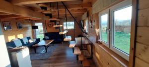 a train room with a table and chairs and windows at Dębowa Chata in Jasło +9 photos