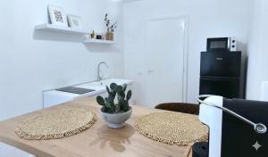 a kitchen with a wooden table with a counter top at La Casa Della Zia Scicli in Scicli