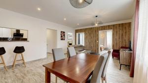 a dining room and living room with a table and chairs at la porte medievale in Carcassonne