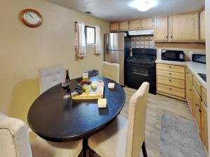 a kitchen with a table with a bottle of wine at A Step Above in Ruidoso