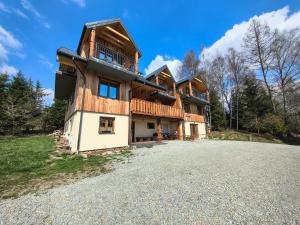 a large house on a hill with a driveway at Noclegi Kamionka in Cisna