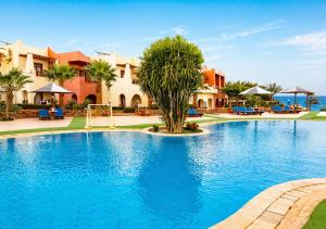 a large swimming pool in a resort at Tropitel Dahab Oasis in Dahab +36 photos
