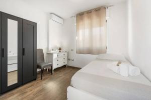 a bedroom with a bed and a dresser and a mirror at Mare e Relax in Quartucciu