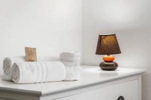 a white counter with towels and a lamp on it at Mare e Relax in Quartucciu
