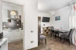 a kitchen and dining room with a table and chairs at Mare e Relax in Quartucciu