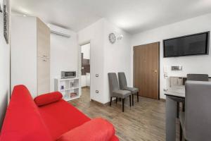 a living room with a red couch and a table at Mare e Relax in Quartucciu