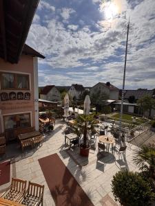 an outdoor patio with tables and chairs at Hotel Vierjahreszeiten in Breitengüßbach