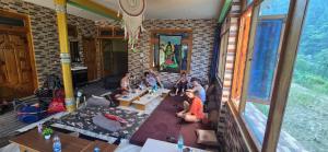 a group of people sitting in a living room at House of Brahma Kasol in Kasol