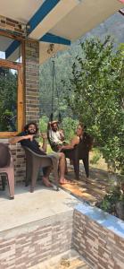 a group of women sitting on benches on a patio at House of Brahma Kasol in Kasol