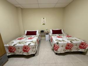 a room with two beds and a table in it at Ducky4 in San Miguel