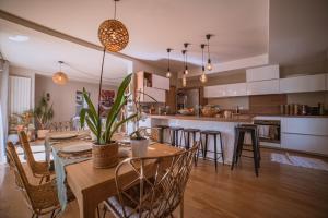 a kitchen and dining room with a table and chairs at Domaine S&B in Aubenas