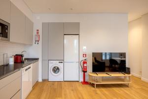a kitchen with a washing machine and a fire hydrant at CapeTown Marula 1BR apartment in Caparica +16 photos