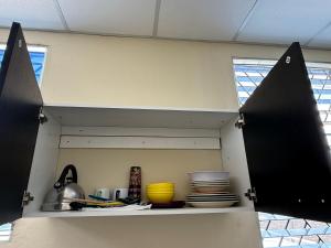 a kitchen shelf with plates and utensils on it at Ducky4 in San Miguel +6 photos