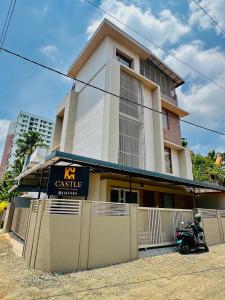 a building with a motorcycle parked in front of it at Castle villa in Cochin +6 photos