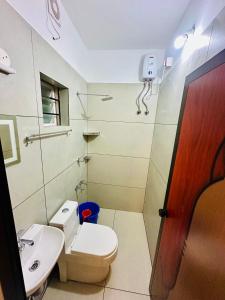 a bathroom with a toilet and a sink at Castle villa in Cochin