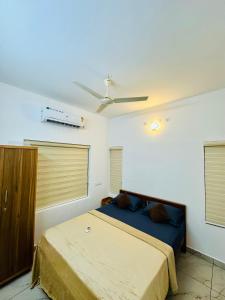 a bedroom with two beds and a ceiling fan at Castle villa in Cochin