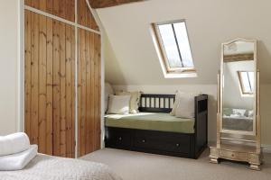 a bedroom with a bed and a mirror at Norton Subedge Barn in Mickleton