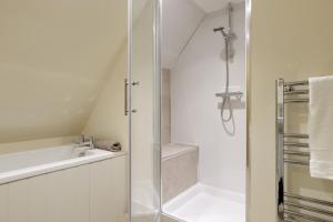 a white bathroom with a shower and a sink at Norton Subedge Barn in Mickleton +48 photos