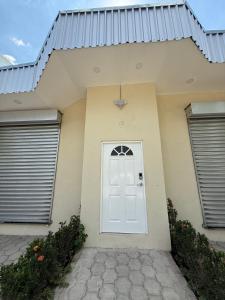 a house with a white door and two windows at Ducky4 in San Miguel