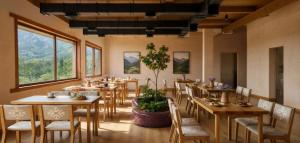 a restaurant with wooden tables and chairs and windows at Kilemche Boutique Hotel & Yurt Camp in Bagysh