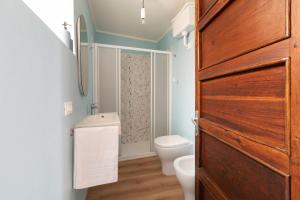 a bathroom with a toilet and a shower at Casa Lidia in Villaretto +30 photos