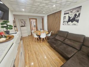 a living room with a couch and a table at MarDeSantaPola in Santa Pola