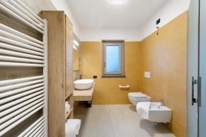 a bathroom with a white toilet and a sink at Appartamenti Suly 3 - Cir0084 in Saint Vincent +8 photos