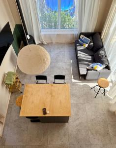 a living room with a table and a couch at Stodoła Dębki in Dębki