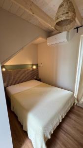 a bedroom with a large white bed in a room at Stodoła Dębki in Dębki