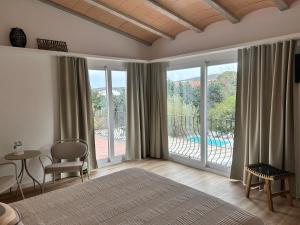 a bedroom with a bed and a balcony with a view at Hotel Misty in Cadaqués