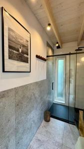 a bathroom with a shower and a window at Stodoła Dębki in Dębki +4 photos