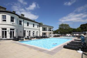 a large swimming pool in front of a white house at Quayside in Christchurch